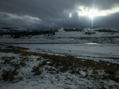 Sun beams over frozen lake in Yellowstone
